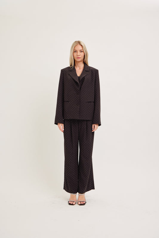 Woman wearing a dark brown suit on a white background