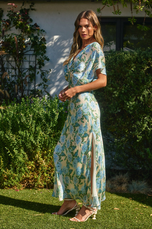 BRITIQUE SILK DRESS WITH BLUE AND GREEN FLORALS WITH SLIT IN ON THE SIDE VIEW OF THE DRESS