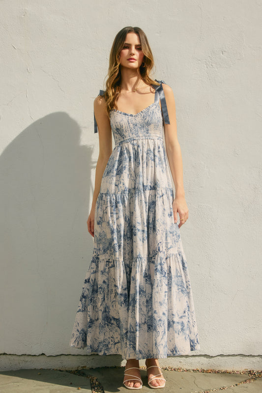 Woman wearing a floral dress against a plain wall