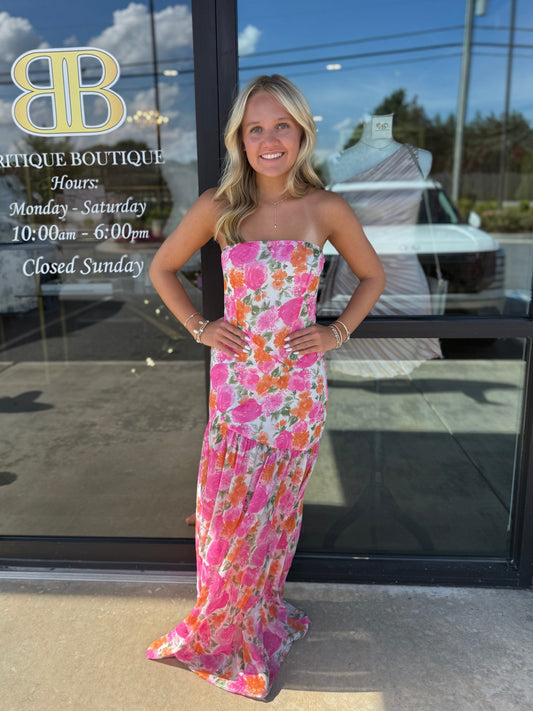 Model in floral maxi dress in front of Britique Boutique
