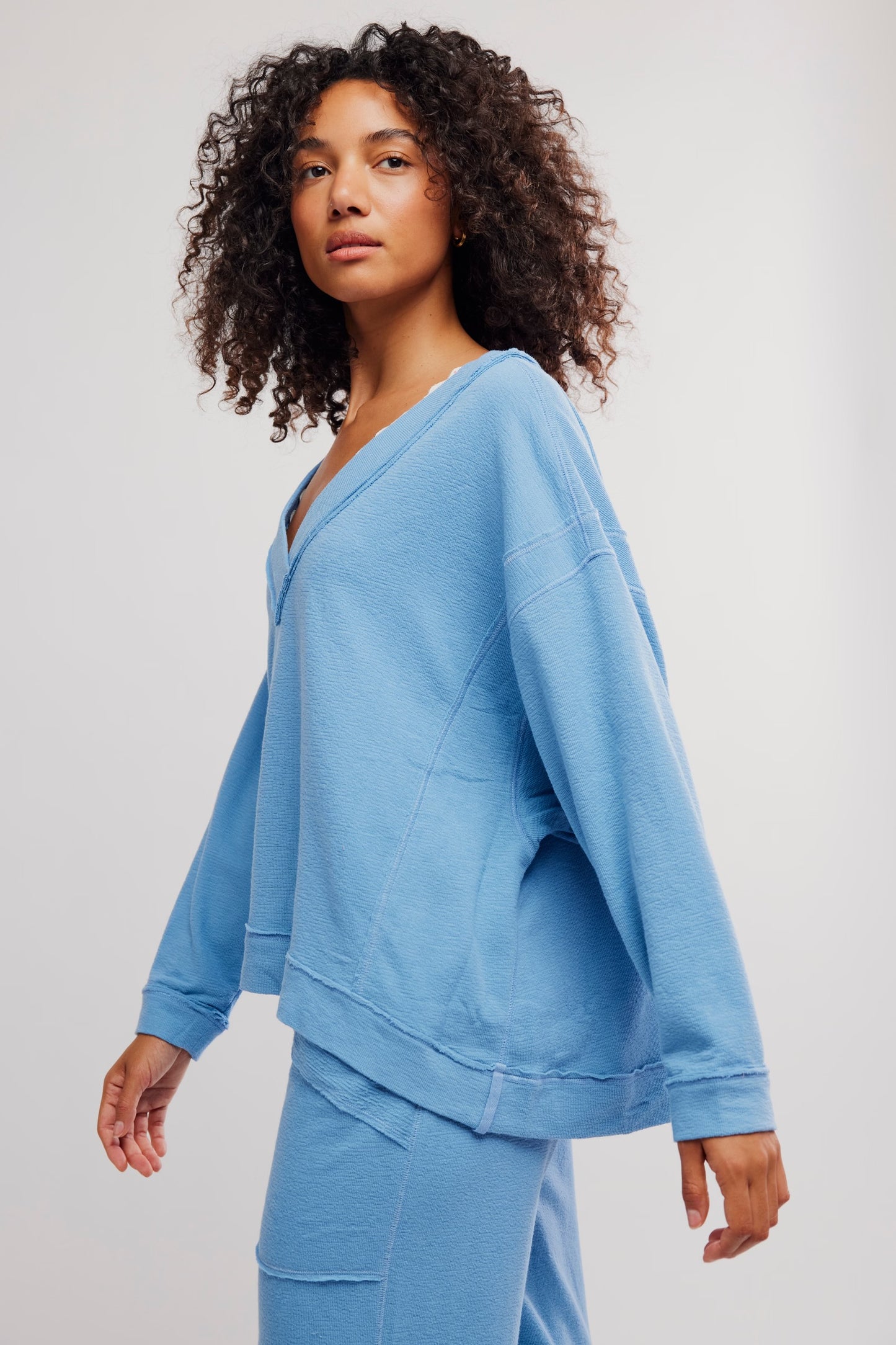 Woman wearing a blue outfit on a plain background