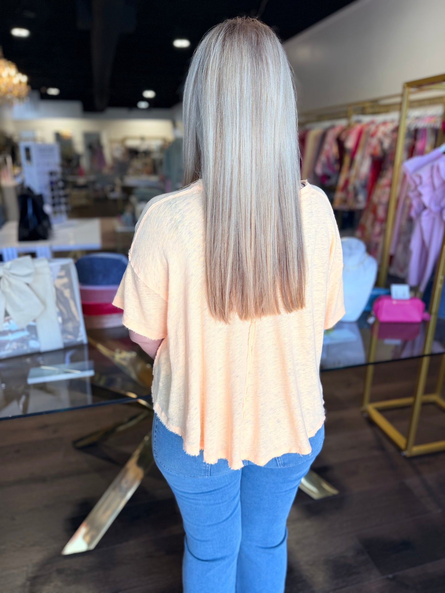 Woman facing backwards with yellow top and blue jeans
