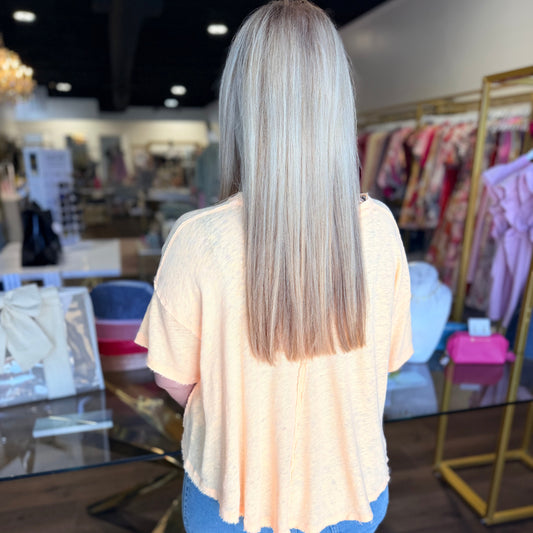 Woman facing backwards with yellow top and blue jeans