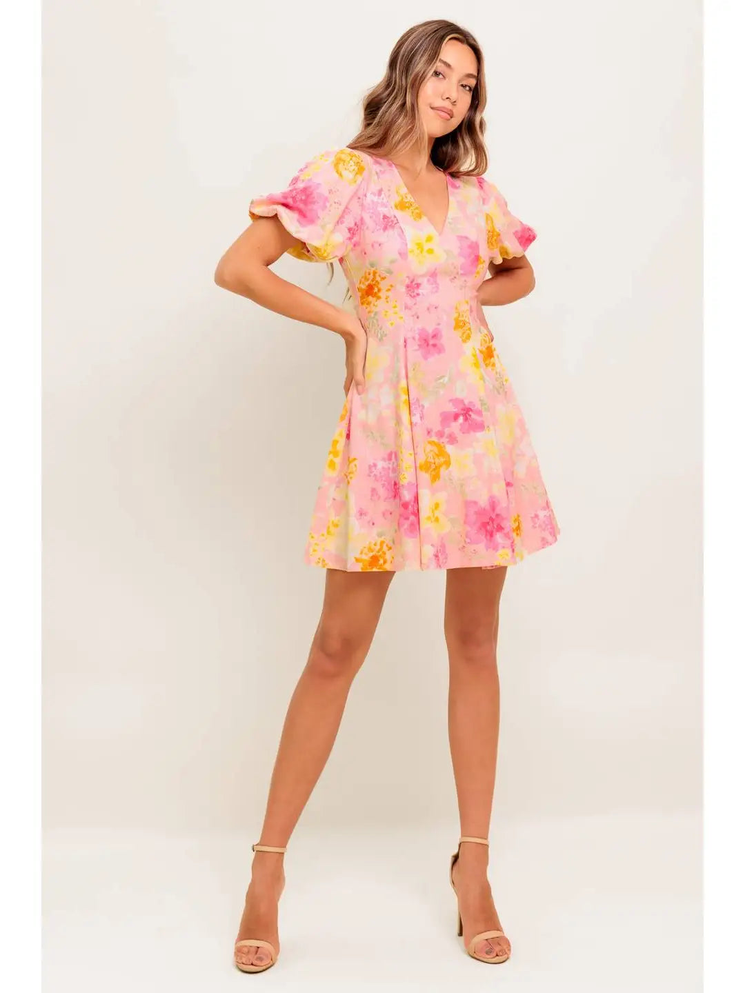Woman wearing a floral dress against a white background
