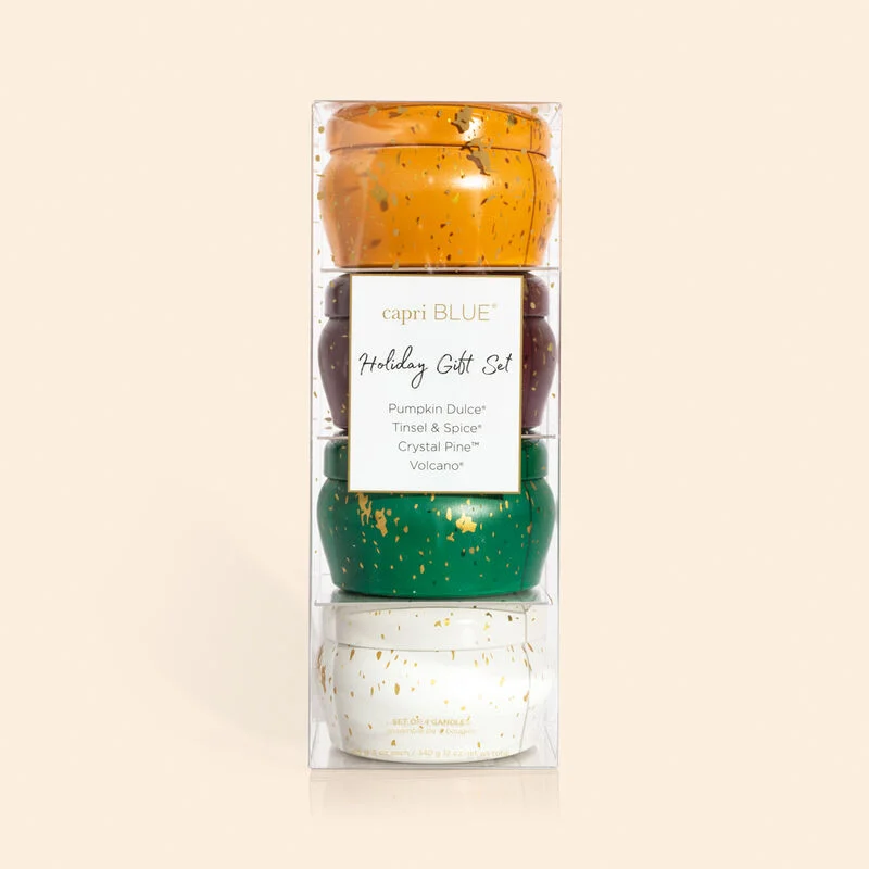 A set of four mini tin candles with holiday fragrances, packaged in a clear acetate carton with a label.