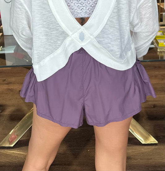 model wearing purple shorts from the back