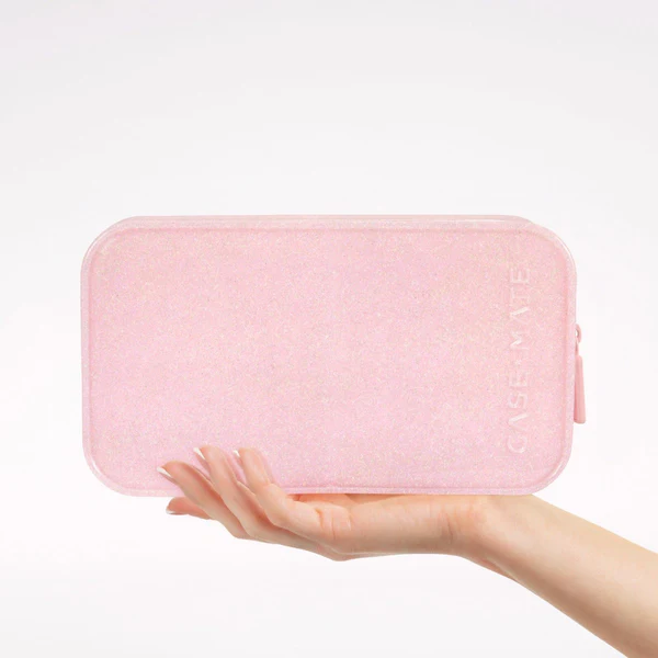 Pink Casemate glitter makeup bag with zipper closure in hand