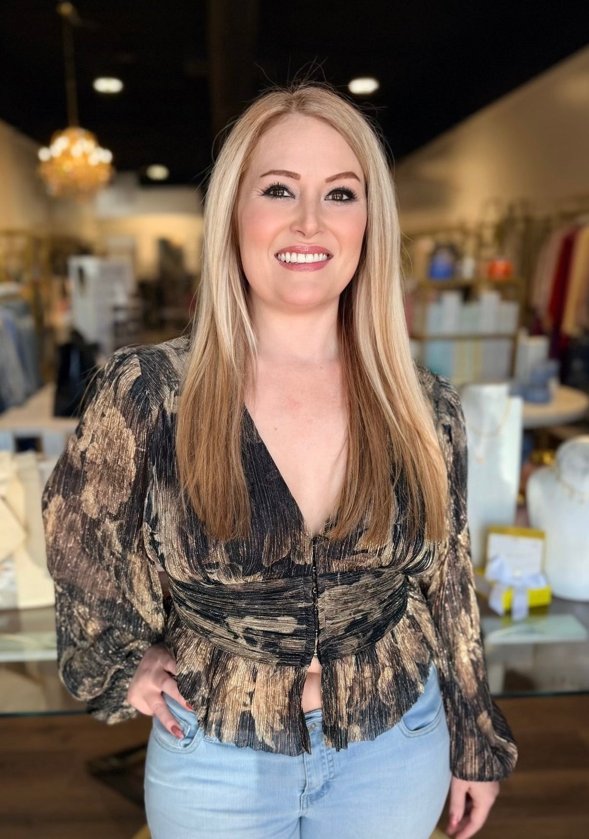 Model in black blouse top in front of the store