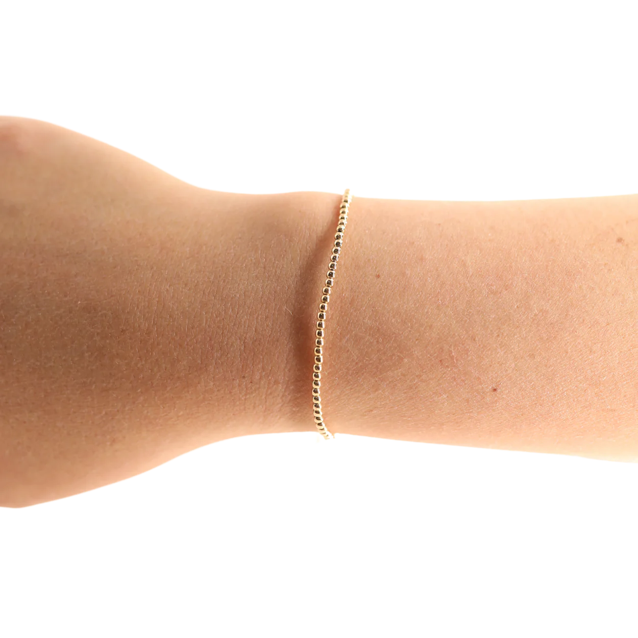 BOUTIQUE BEADED BLONDES 2MM GOLD BRACELET ON ARM