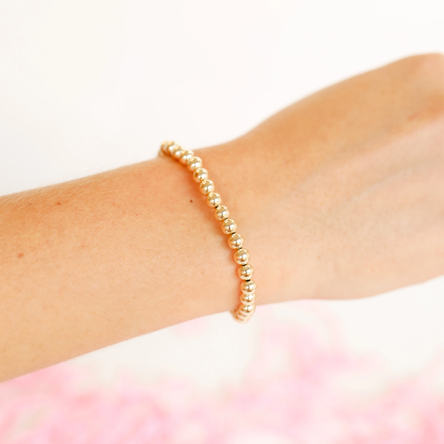 BOUTIQUE BEADED BLONDES 5MM GOLD BRACELET ON ARM