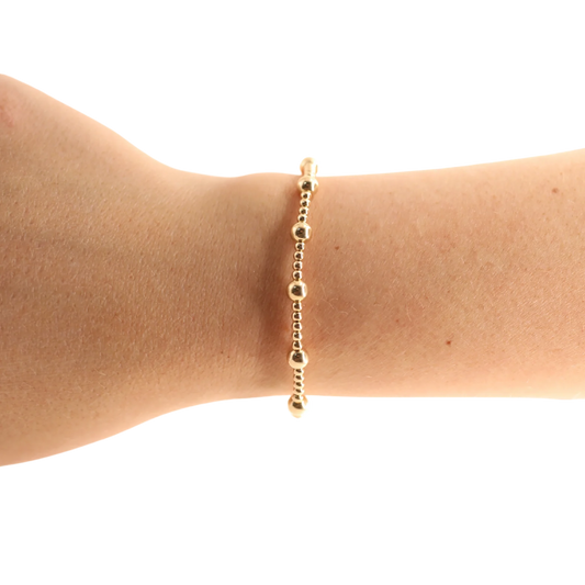 BOUTIQUE BEADED BLONDES GOLD LIVELY BRACELET ON ARM