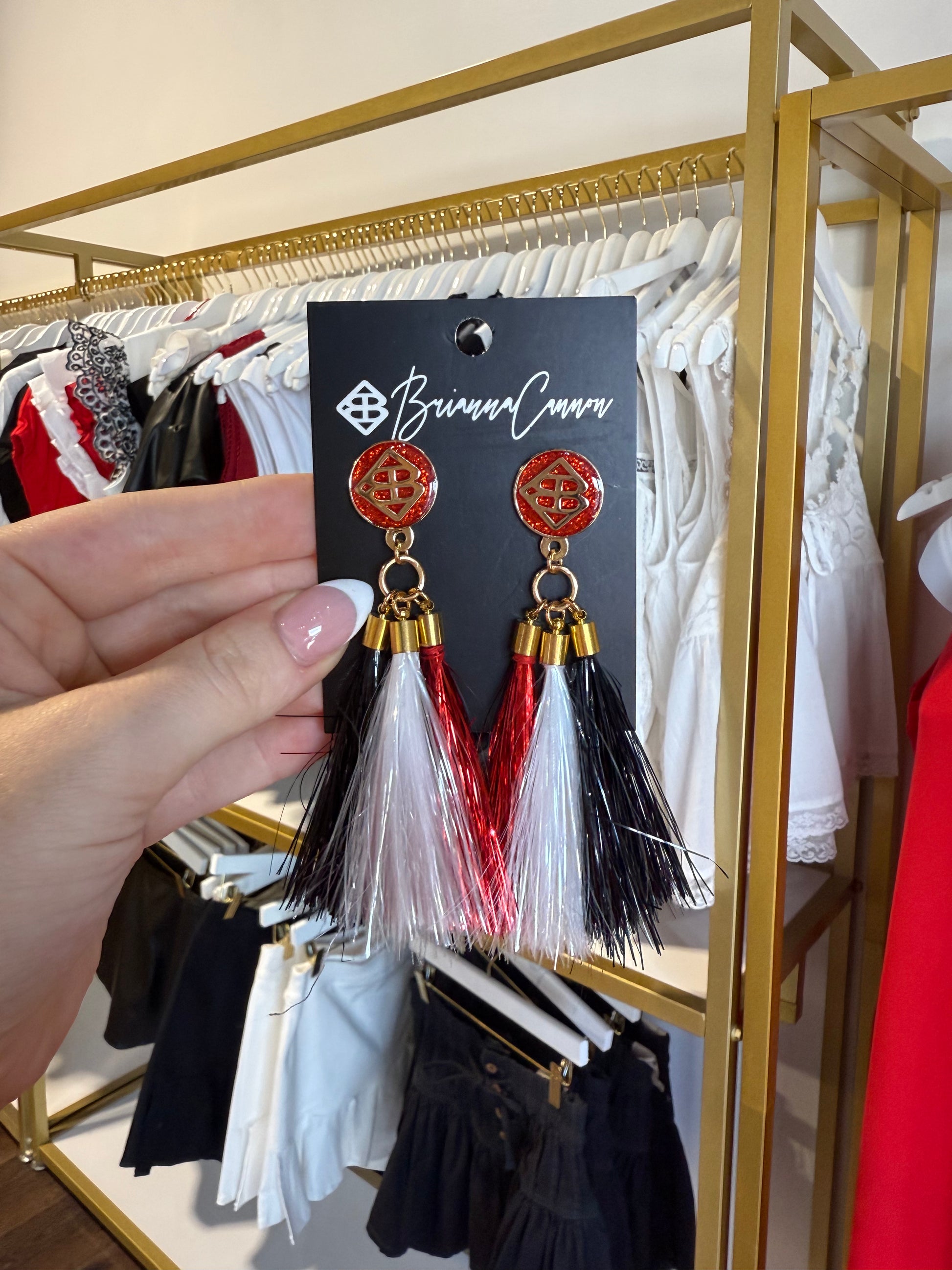 BOUTIQUE BRIANNA CANNON METALLIC JUMBO TASSEL EARRINGS IN HAND