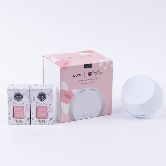 Pura smart fragrance diffuser set with packaging on a white background