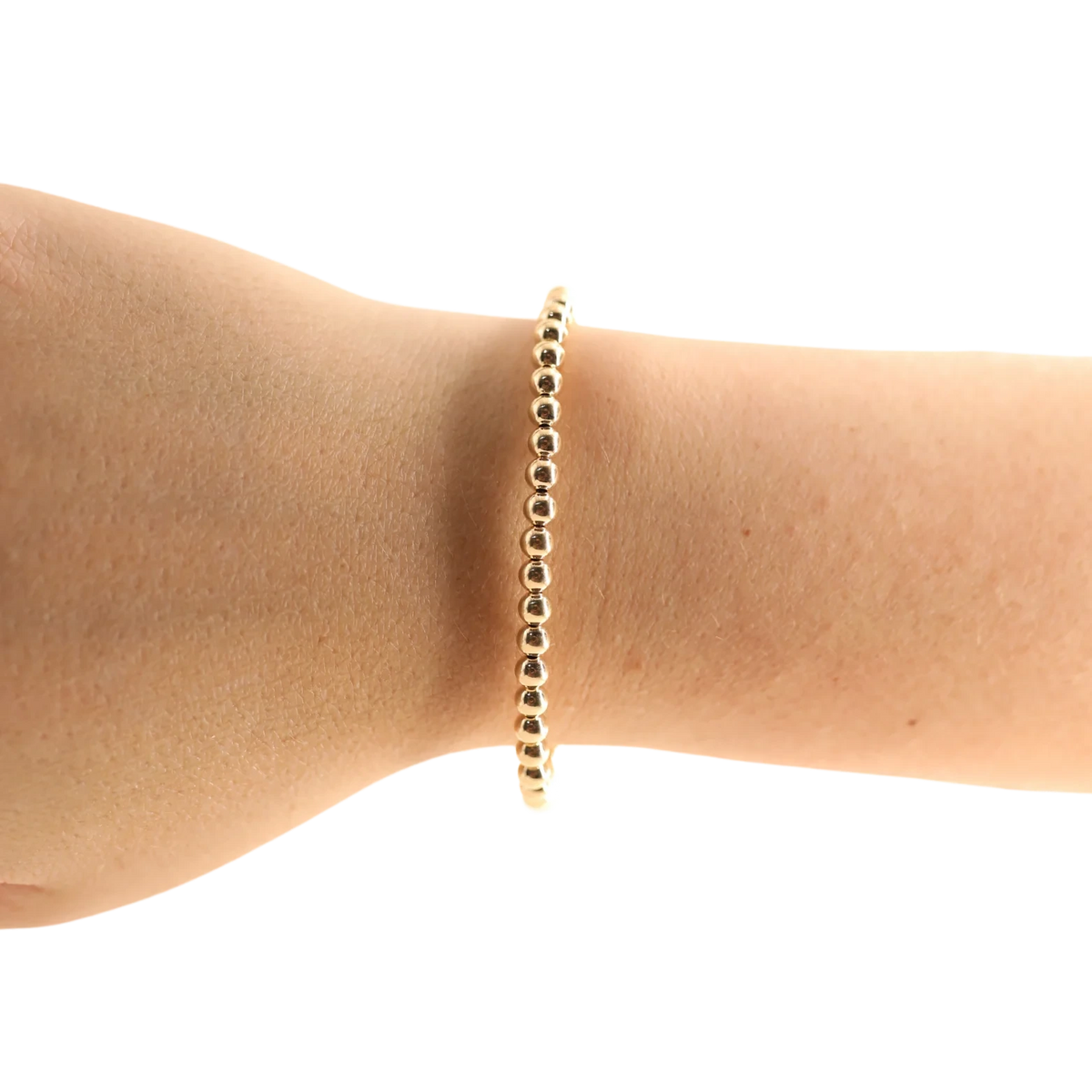Beaded Blondes 4mm Gold Bracelet worn alone on a wrist.