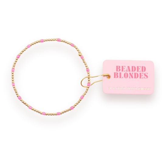 Hot Pink Dainty Poppi Bracelet arranged in a circle with a pink Beaded Blondes tag.