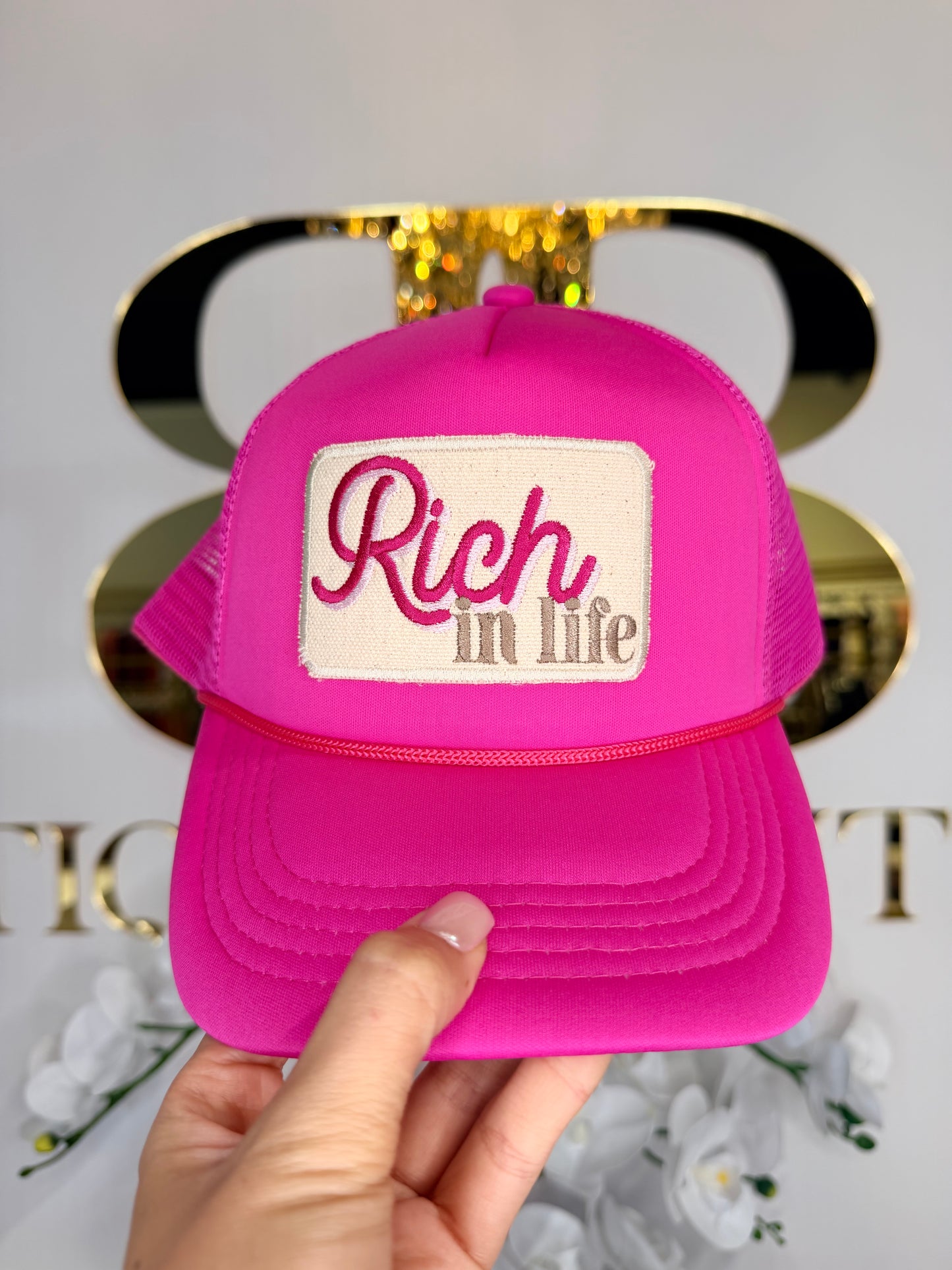 Pink hat that says rich in life