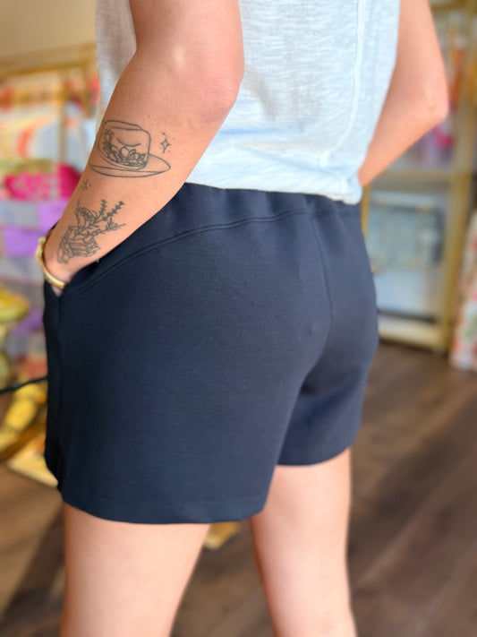 model wearing black shorts from the back