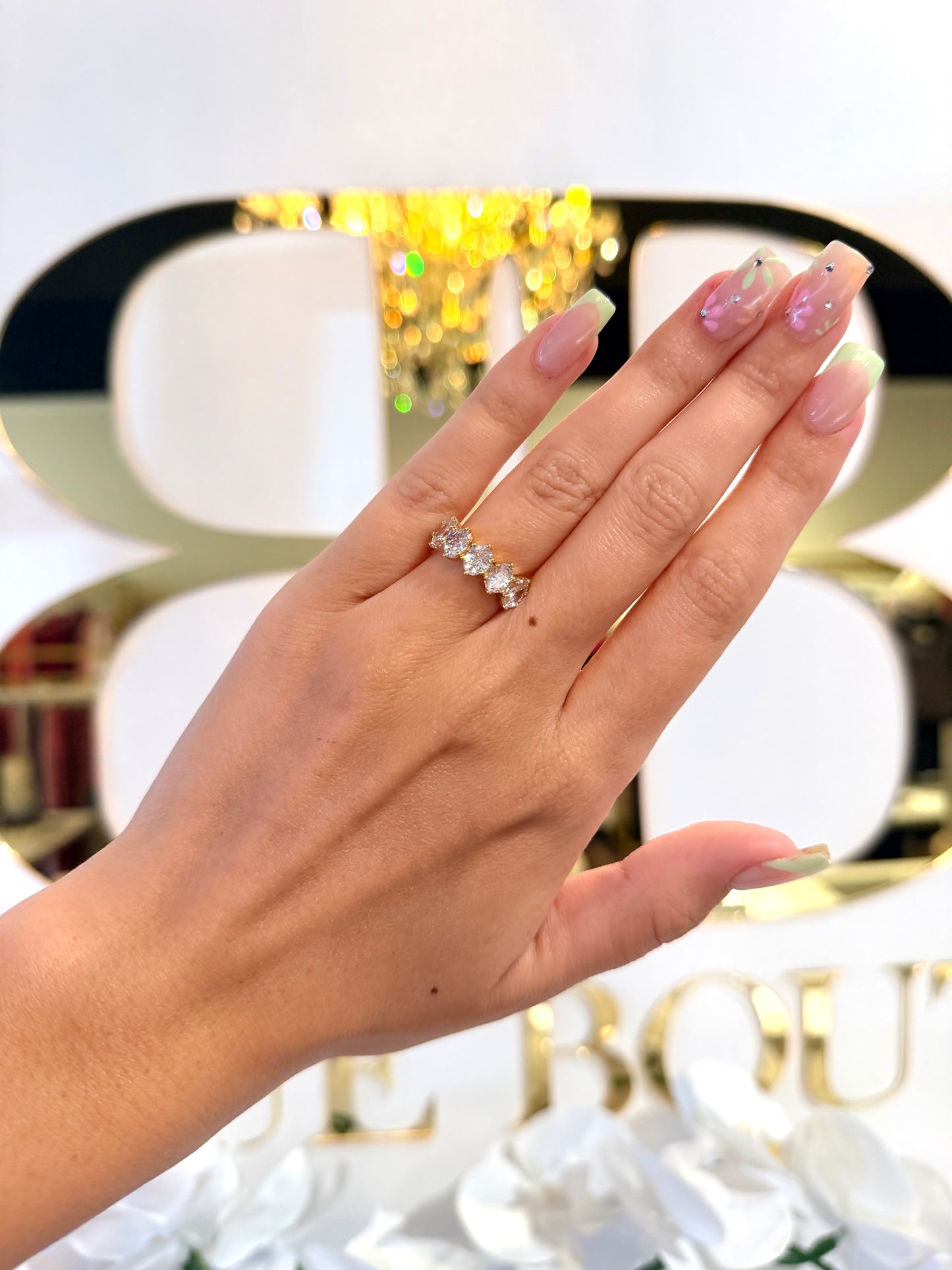 Diamond ring on hand in front of bb