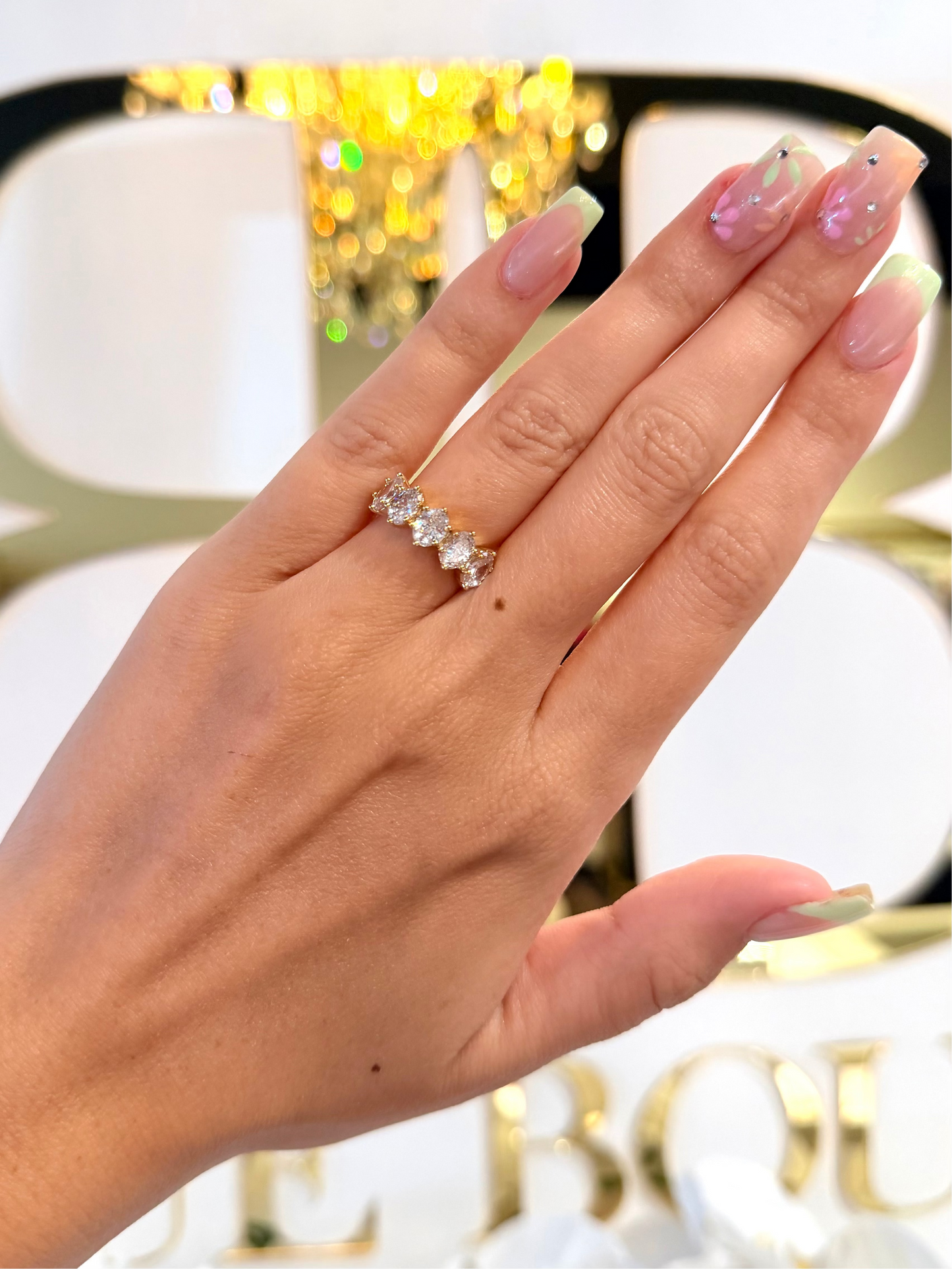 Diamond ring on hand in front of bb