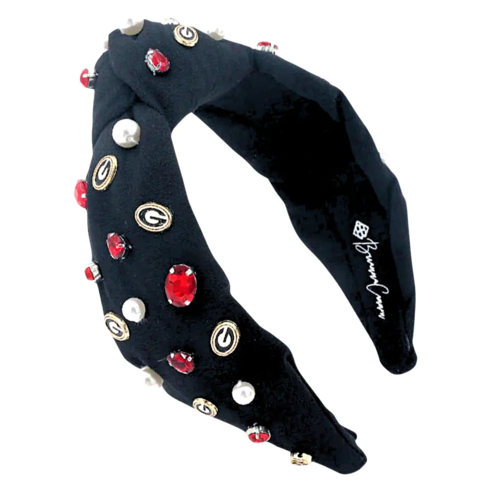 Black headband with colorful embellishments on a white background