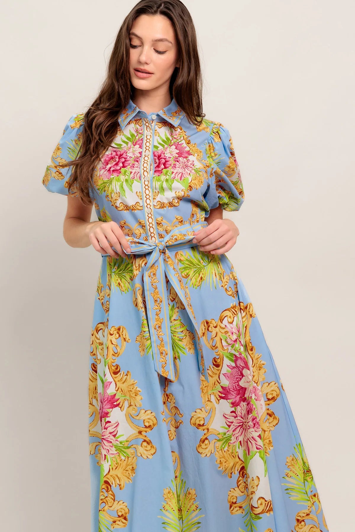 Woman wearing a floral dress with a light blue background