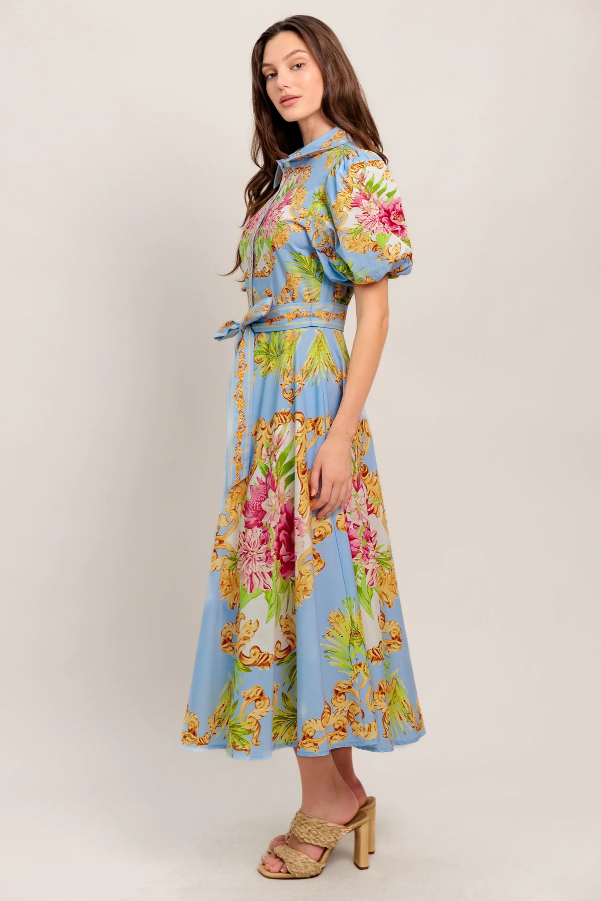 Woman wearing a floral dress with a light background
