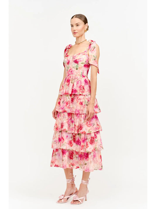 model wearing floral dress standing to the side