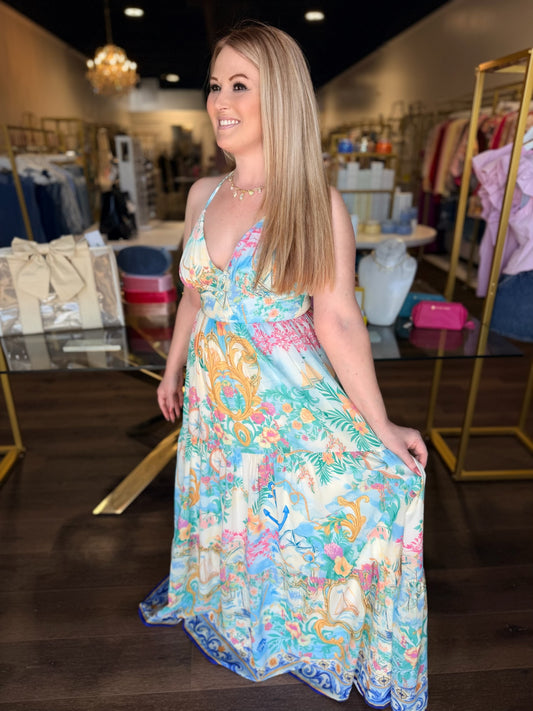 Woman wearing a colorful floral dress in a store setting