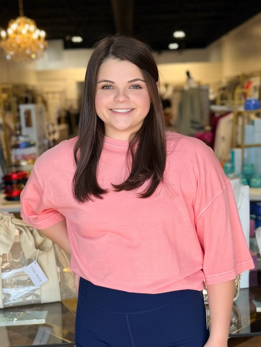 Model standing infront of store in oversized tee and navy biker shorts