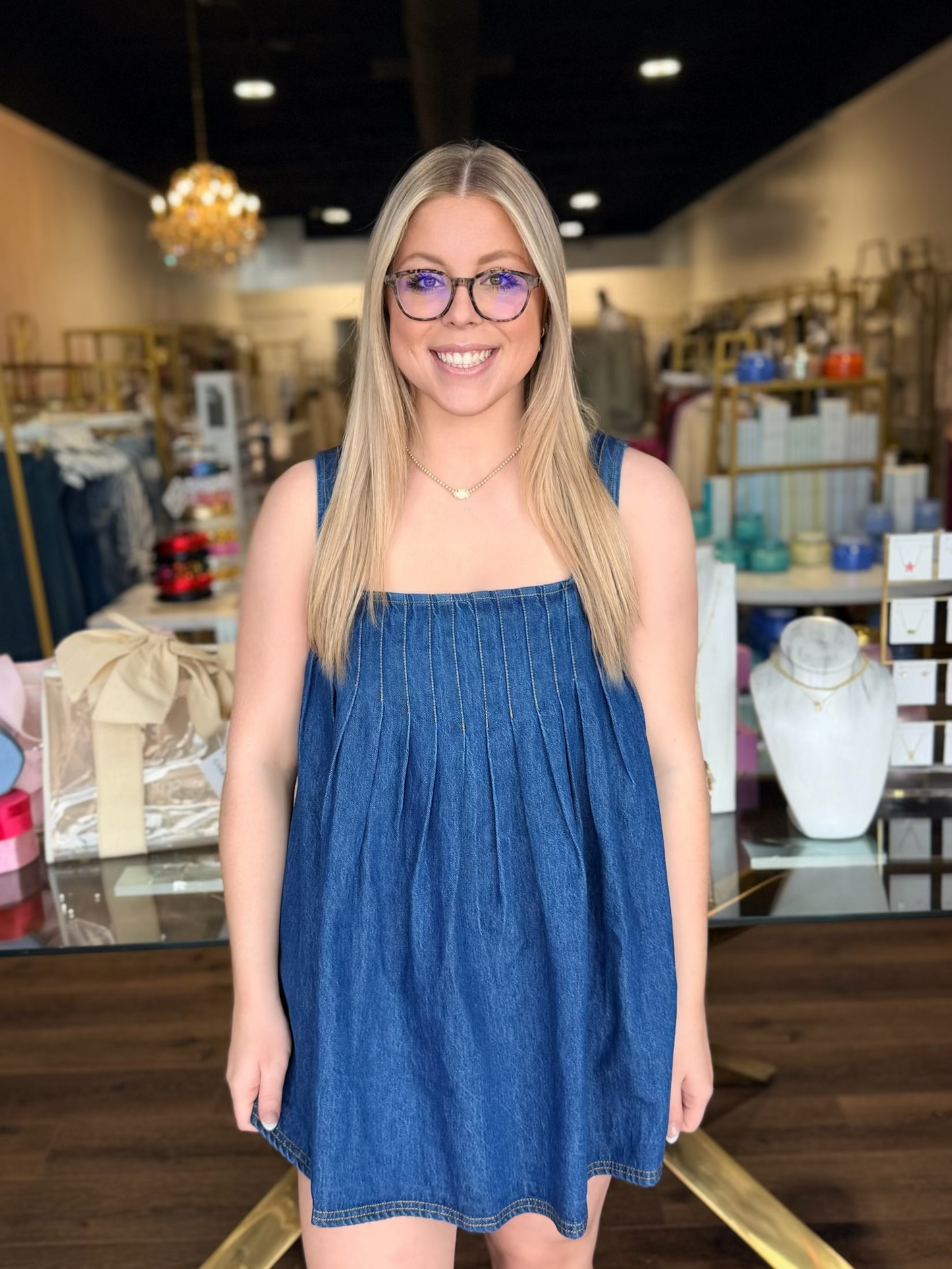 Model standing in front of store in free people tunic dress