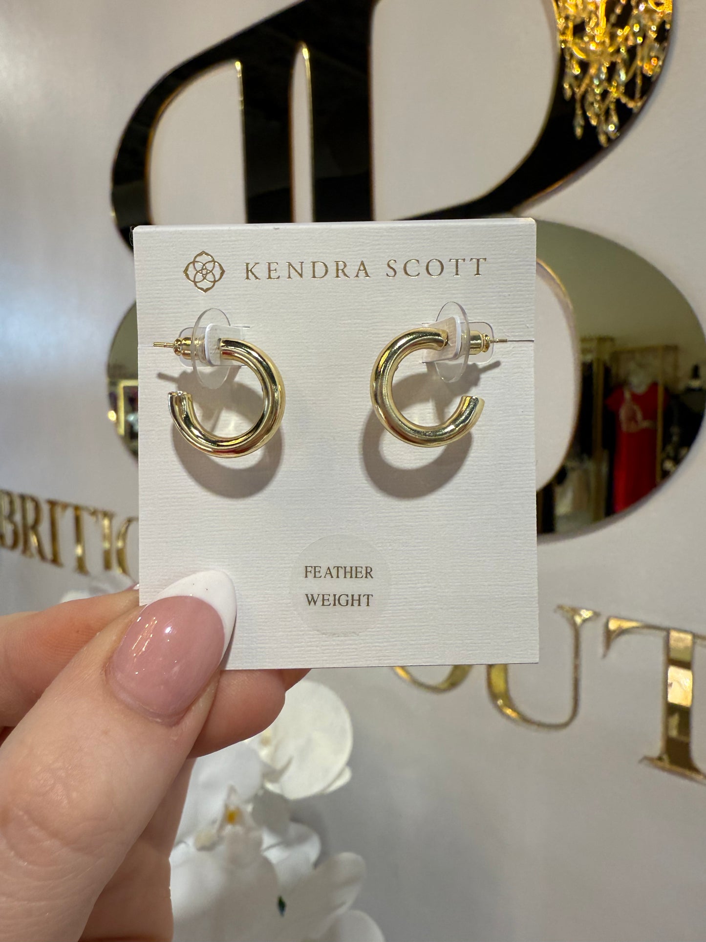 BOUTIQUE KENDRA SCOTT COLETTE GOLD HUGGIE EARRINGS IN HAND