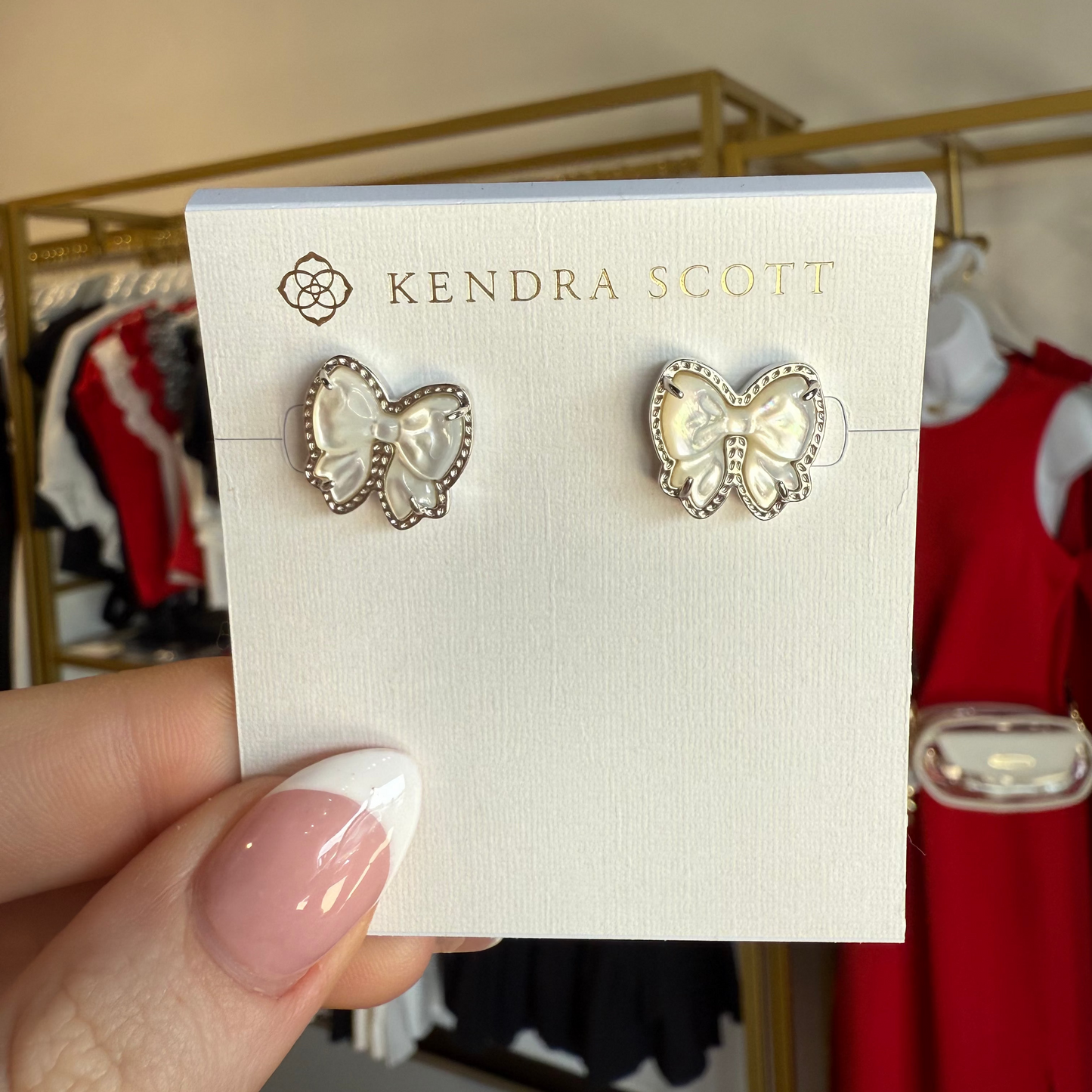 BOUTIQUE KENDRA SCOTT HALEY BOW STUD EARRINGS SILVER IVORY MOTHER OF PEARL IN HAND