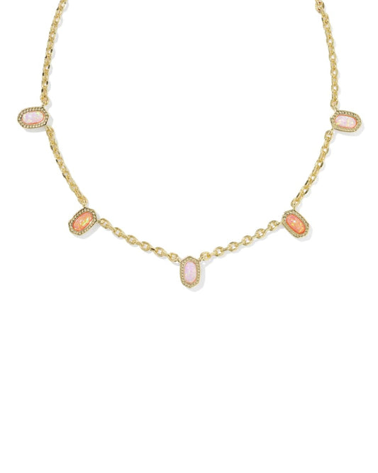 Gold necklace with pink gemstones on a white background