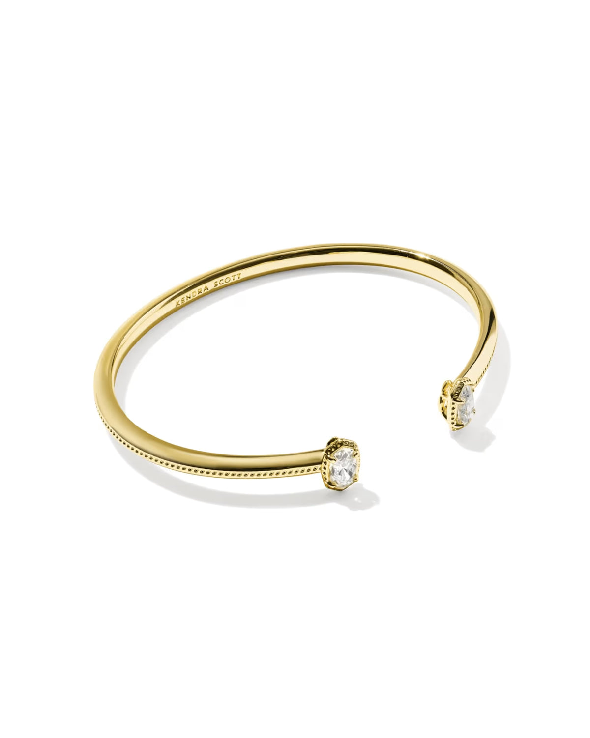 Kendra Scott gold luxe cuff on white background.