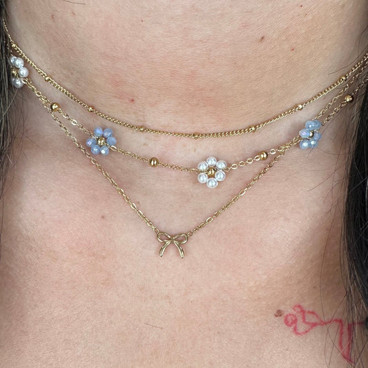 BOUTIQUE LINNY CO GOLD FLOWER BLUE PEARL GRACIE NECKLACE ON MODEL
