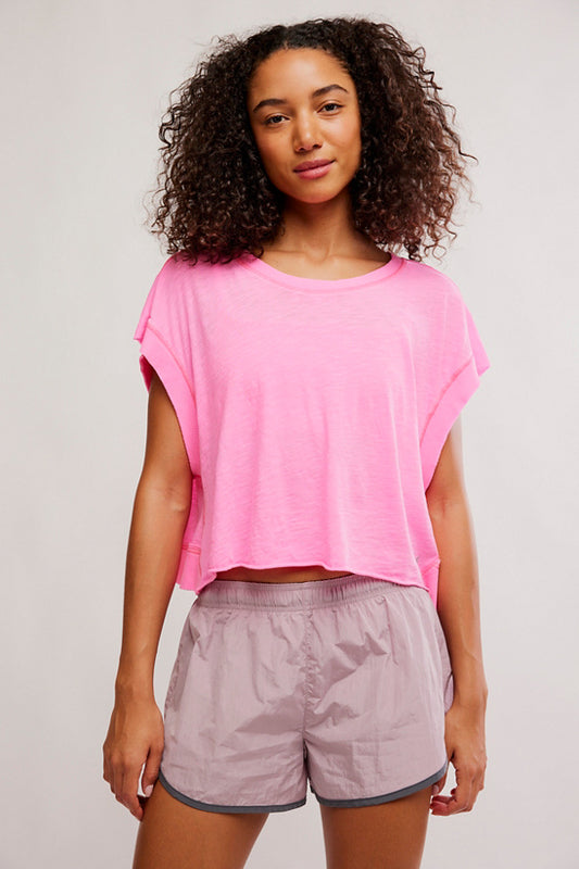 model wearing pink shirt with mauve shorts on a white background