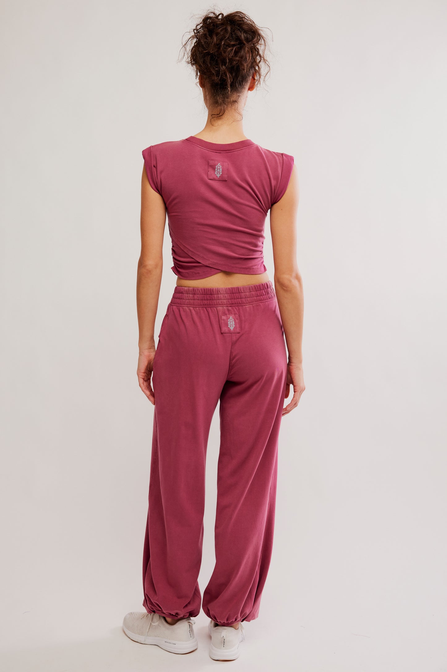 Person wearing a pink athletic outfit on a plain background