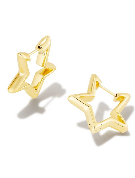 A pair of gold-colored star-shaped huggie earrings against a white background.