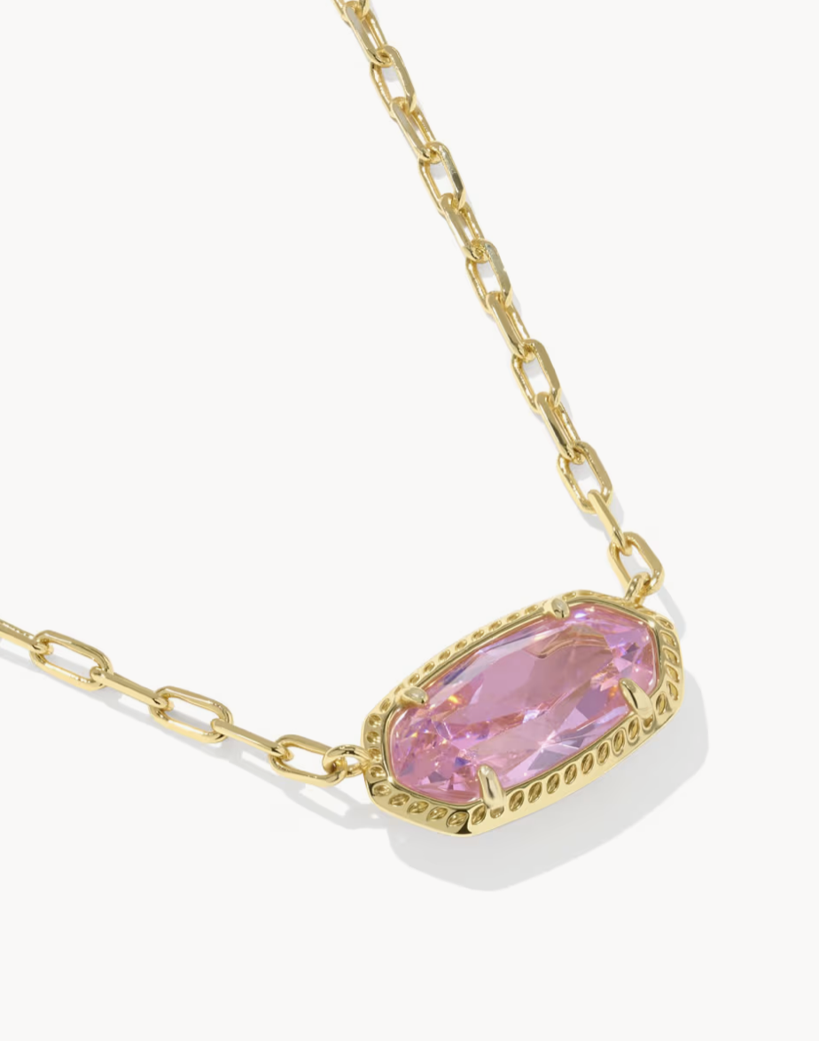 Necklace with a pink gemstone and gold chain on a white background
