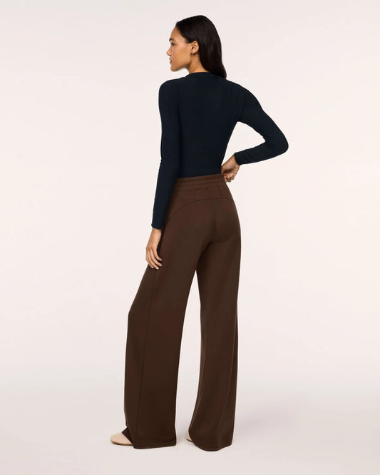 Model wearing Spanx Wide Leg Pants Umber Root back view with white background.
