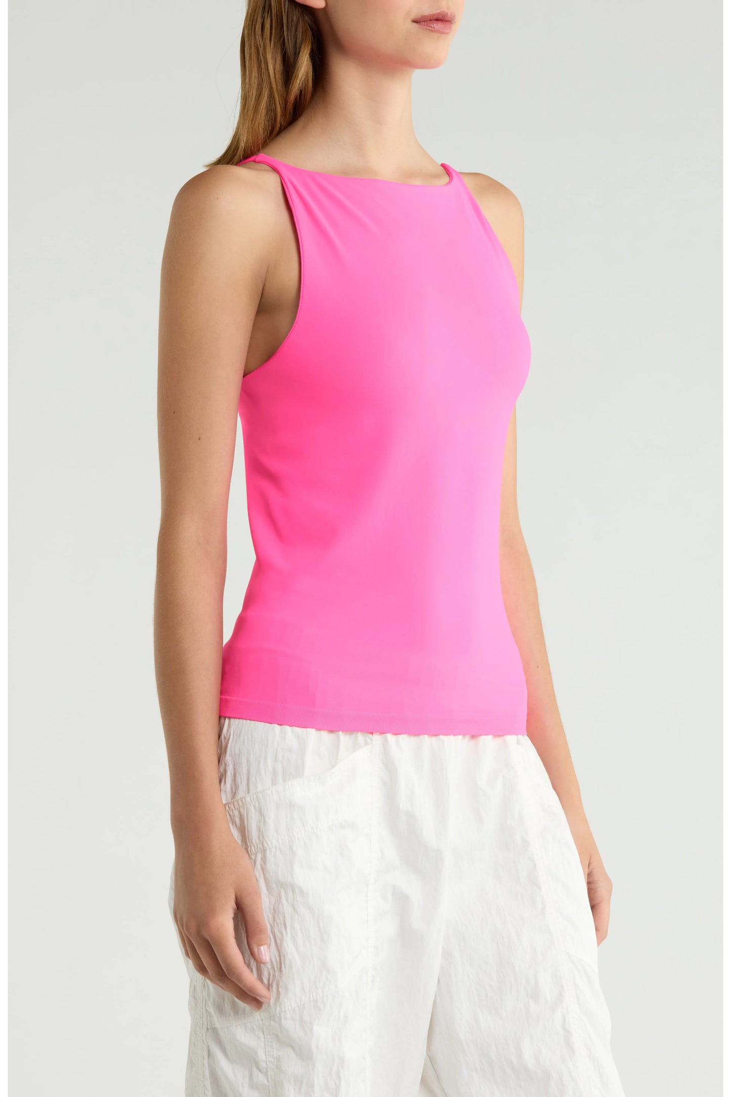 Britique Boutique model wearing Free People Hummingbird Pink Top side view with white background