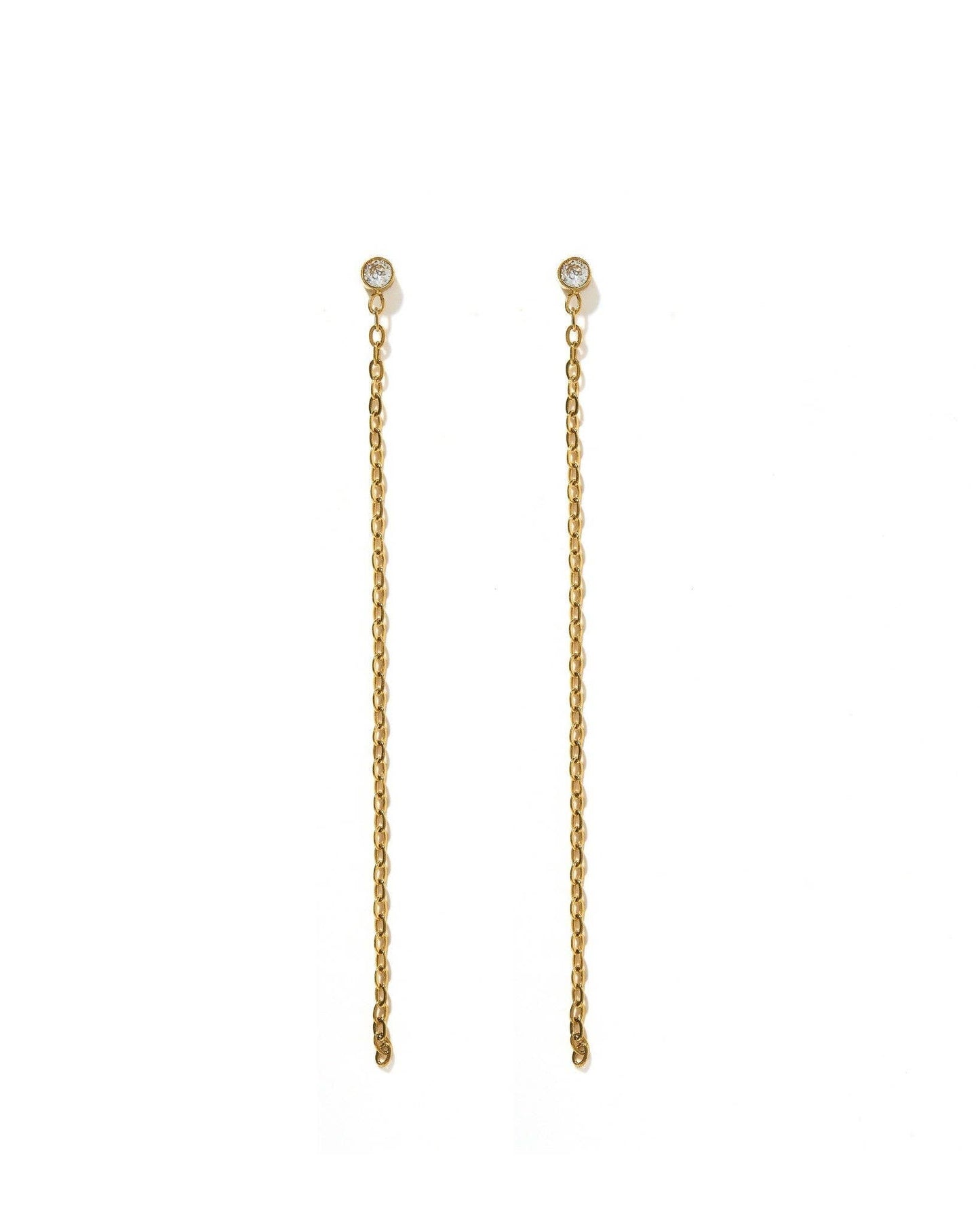 A pair of gold drop earrings with a small round clear stone at the top and a long, delicate chain dangle below, shown on a plain white background.