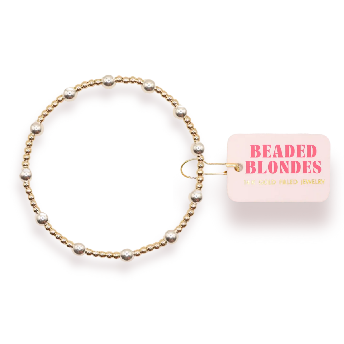 A gold beaded stretch bracelet with silver-toned pearl-like beads, shown next to a pink tag that reads 'BEADED BLONDES'.