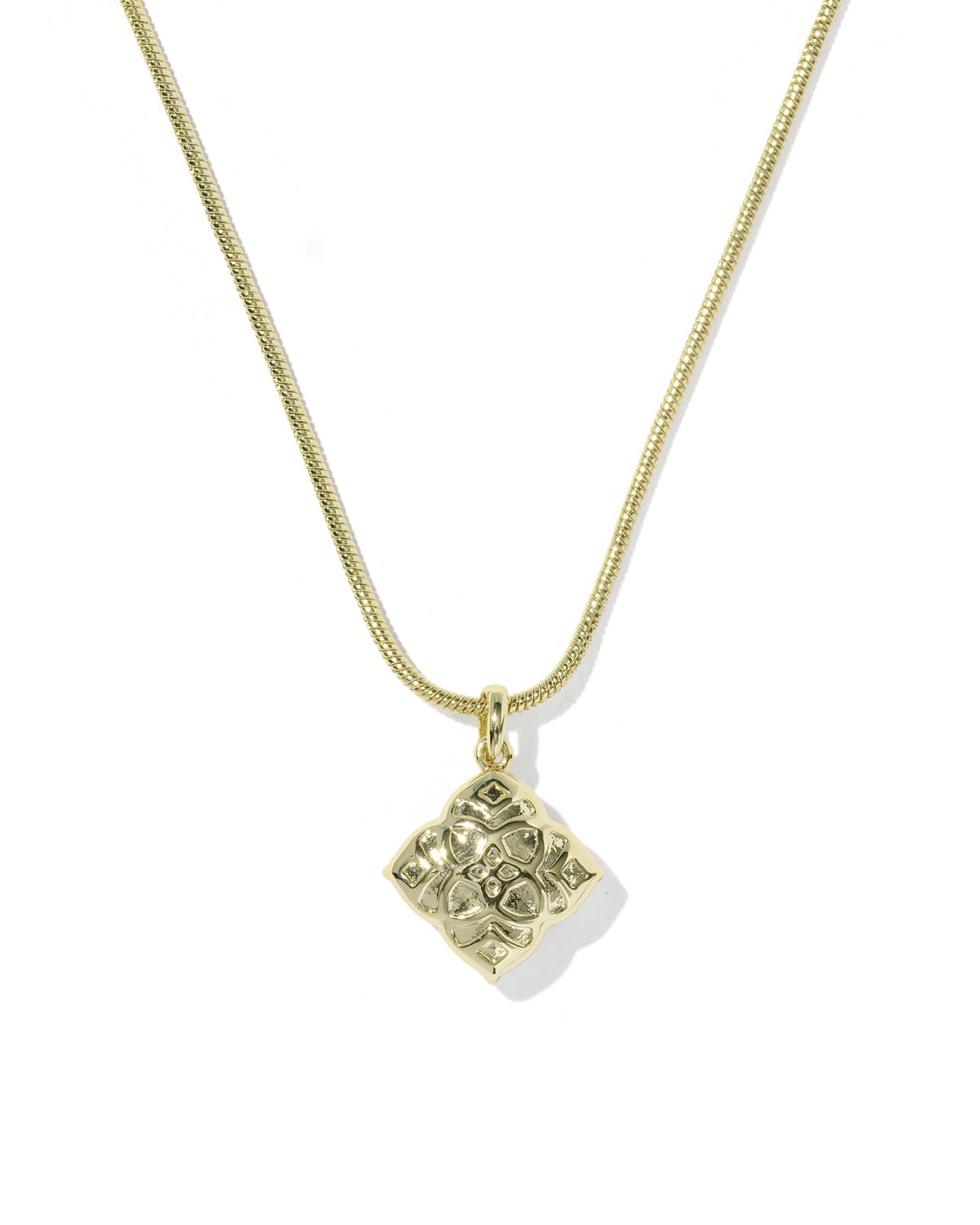 Gold necklace with a square pendant on a white background