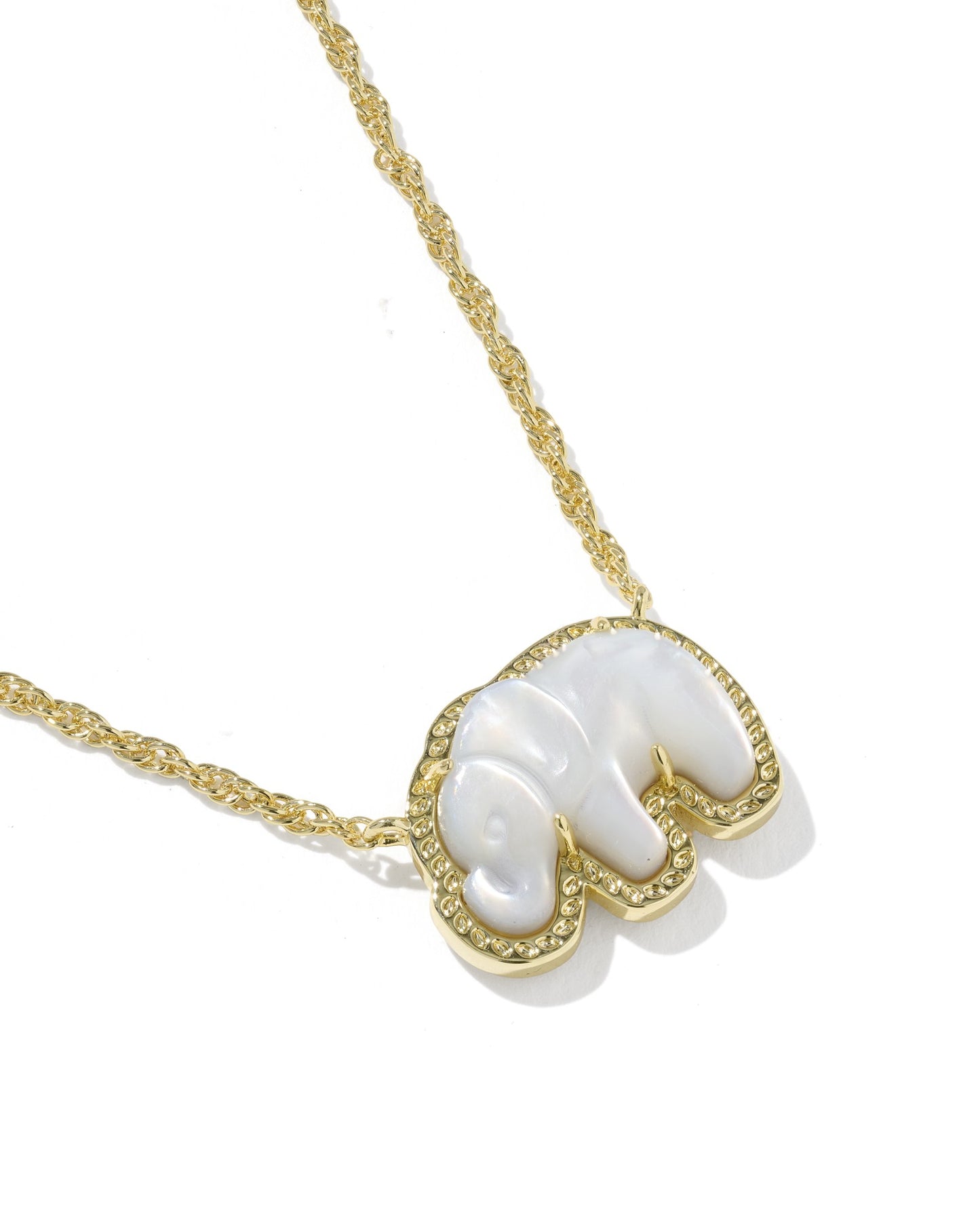 Gold necklace with a white pendant on a white background