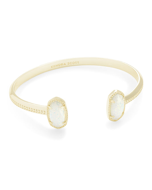 Gold ring with opal stones on a white background