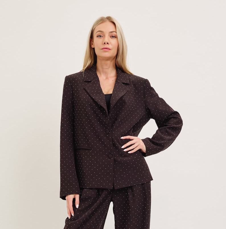 Woman wearing a brown suit against a white background