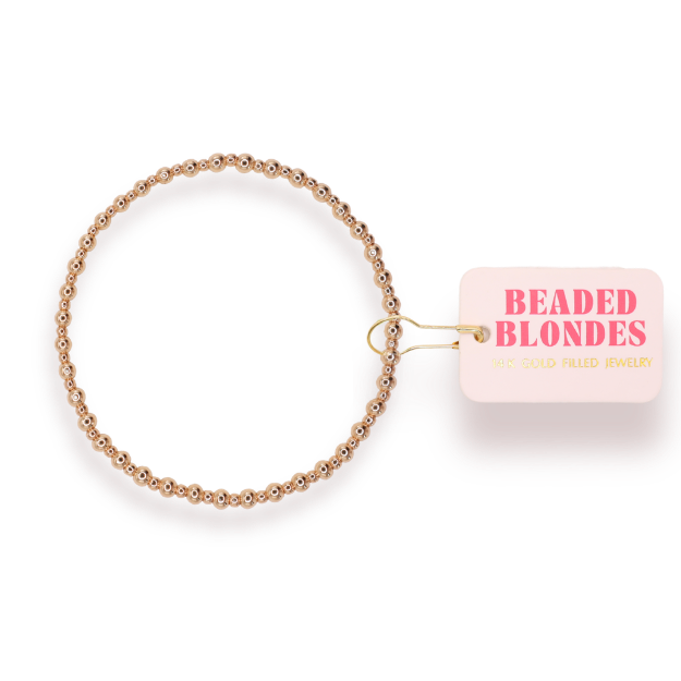 Gold beaded bracelet with 'Beaded Blondes' label on a white background