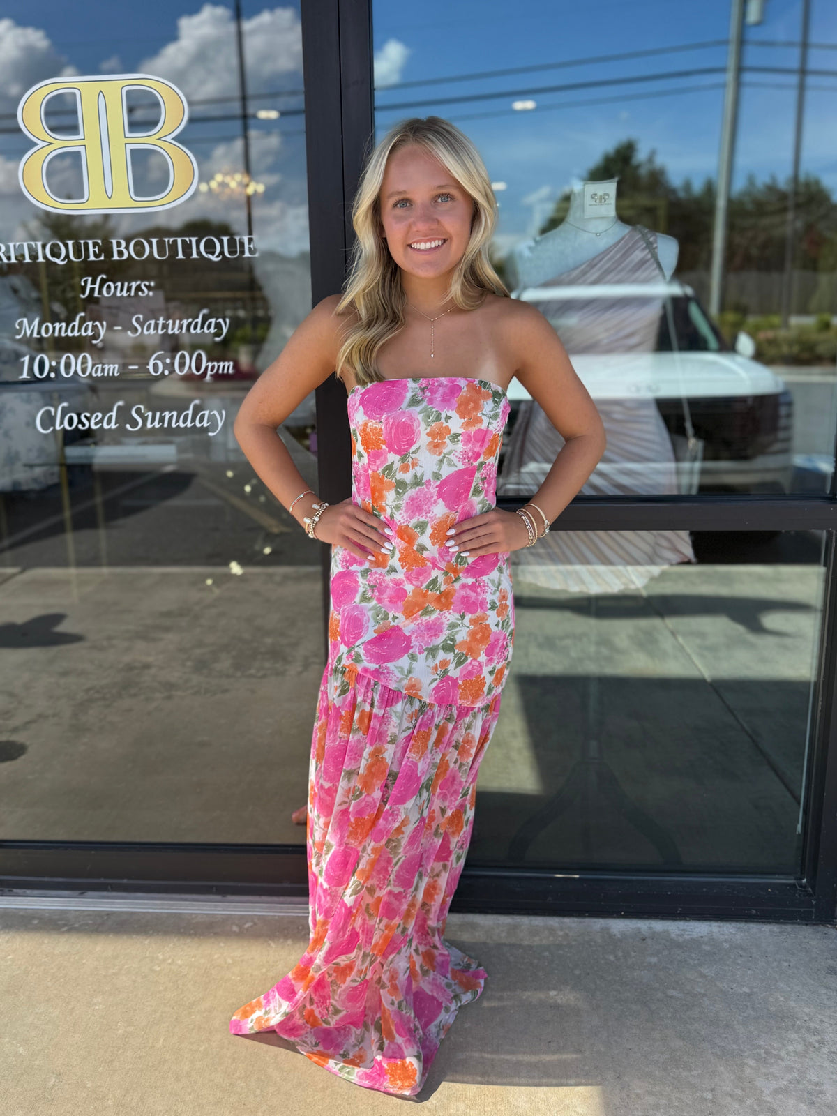 Model in floral maxi dress in front of Britique Boutique 