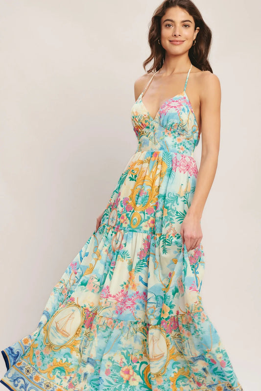 Woman wearing a colorful floral dress on a plain background